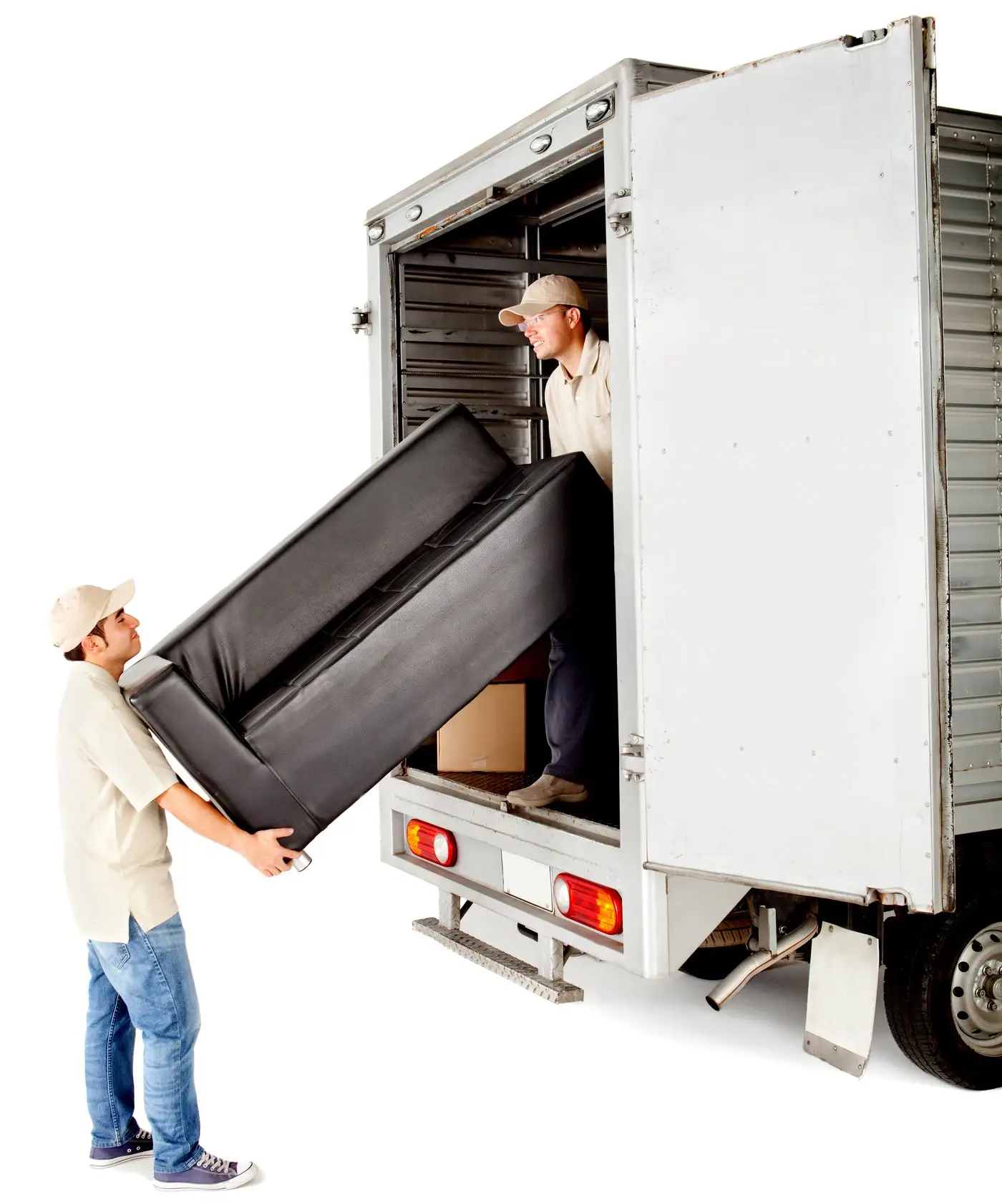 Two workers loading a black sofa into a removal truck